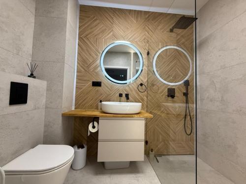 a bathroom with a sink and a mirror at Jarzebinowa Loft III by JumpInHere in Nowy Dwór Mazowiecki
