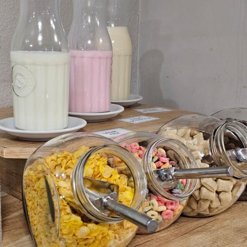 a table with two plates of food and milk at Hotel Bariloche Ski in San Carlos de Bariloche