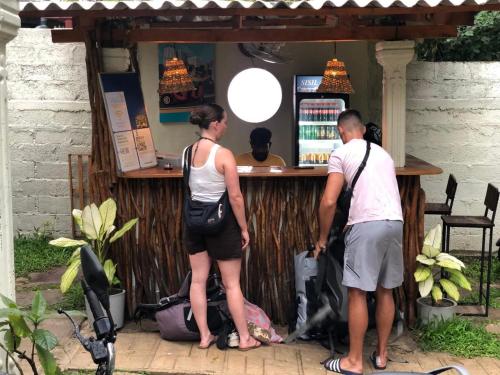 a man and a woman standing at a bar at Wake N Flow, Ahangama - Kabalana Beach in Ahangama