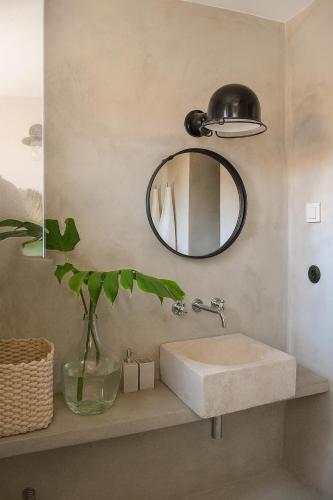 a bathroom with a sink and a mirror at Campo de Santa Clara 98 in Lisbon