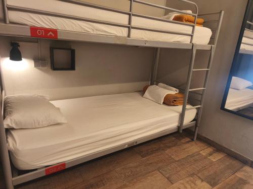 a room with two bunk beds and a mirror at Buba House - Women Only Hostel in Barcelona