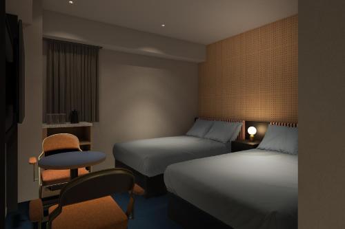 Ένα ή περισσότερα κρεβάτια σε δωμάτιο στο BASE LAYER HOTEL Fukuoka