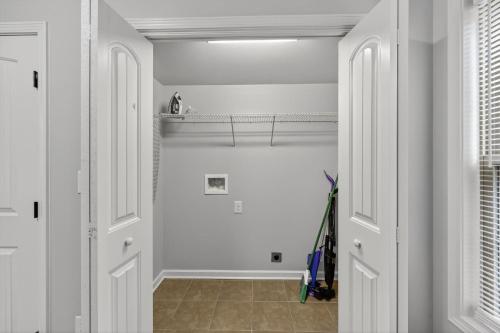 a hallway with white walls and white doors at Inviting 2BR hideaway with contemporary touches in Clarksville