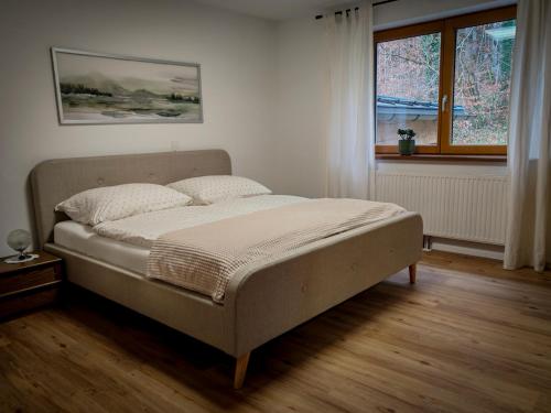 a bed in a bedroom with a window at Ferienwohnung Doppelreiter in Ebbs