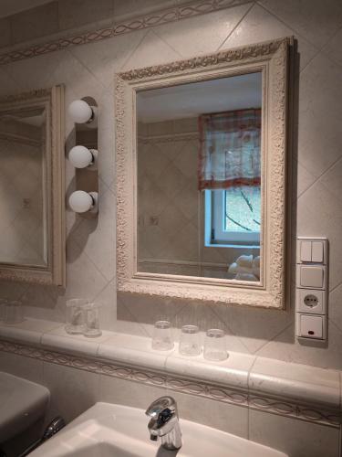 a bathroom with a sink and a mirror at Ferienwohnung Doppelreiter in Ebbs