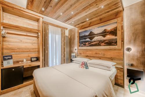 Ένα ή περισσότερα κρεβάτια σε δωμάτιο στο Hotiday Sauze Centro