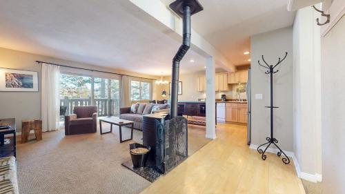 a living room with a fireplace and a kitchen at Western Slopes Villas #7 condo in Mammoth Lakes
