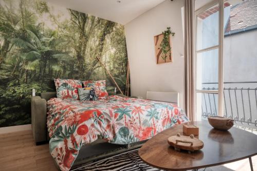 En eller flere senge i et værelse på Green Oasis Proche Gare & Disneyland