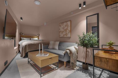 a living room with a couch and a bed at Tromsø Studio - in the heart of the city in Lii