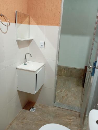 a bathroom with a shower and a sink and a toilet at Pousada Encanto dos Olhos in Alexânia