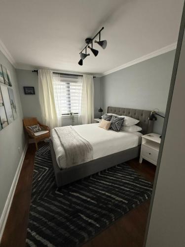 a bedroom with a large bed and a window at Modern Retreat with Hot tub by YYZ, 20min to CN Tower in Toronto