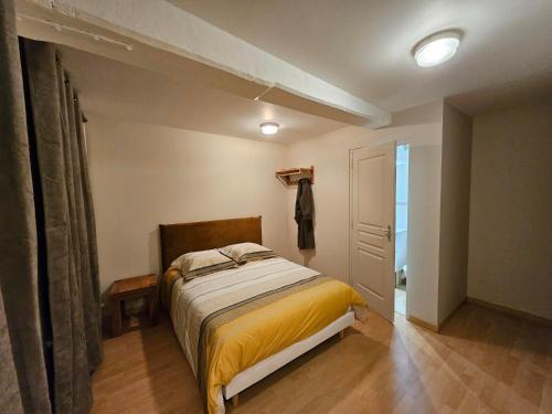 a bedroom with a bed and a closet and a door at Murmures de la Risle in Pont-Audemer