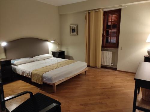 a bedroom with a large bed and a wooden floor at Rosa dei Venti in Rapallo