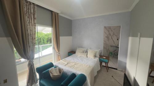 Ένα ή περισσότερα κρεβάτια σε δωμάτιο στο Residência da Kel