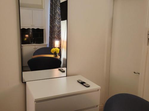 a room with a mirror and a table and chairs at Cosy in Cork in Cork