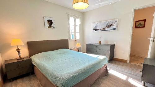 a bedroom with a bed and a television in it at Superbe villa avec piscine dans le village de St Clément in Saint-Clément-des-Baleines