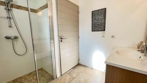 a bathroom with a shower and a sink at Superbe villa avec piscine dans le village de St Clément in Saint-Clément-des-Baleines