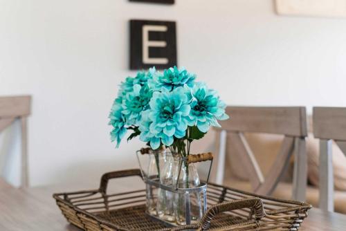 a glass vase with blue flowers on a table at Ozark Overlook Escape - For 6 in Branson West