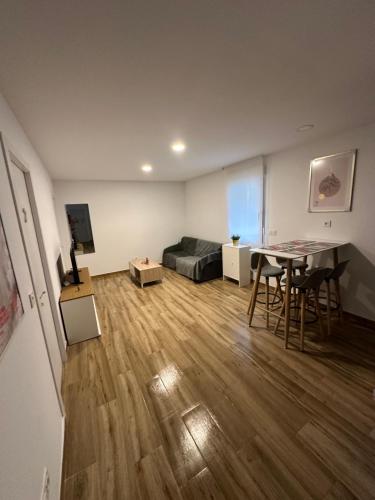 Ribera y Gastronomía في اراندا دي دويرو: غرفة معيشة بها سرير وطاولة وكراسي