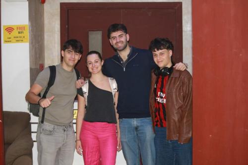 un grupo de personas de pie delante de una puerta en INTERNATIONAL HOSTEl, en Mascate