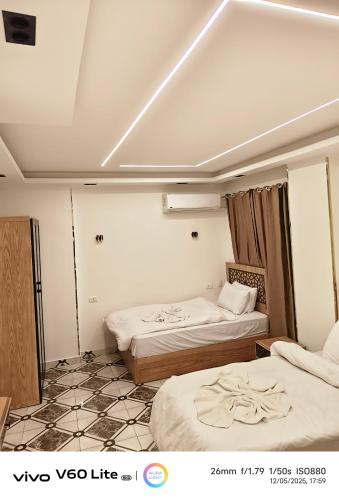 una habitación con dos camas en una habitación en Pyramids zh inn, en El Cairo