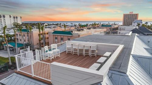 a balcony with tables and chairs on top of a building at Sunset Lagoon Estate in Siesta Key