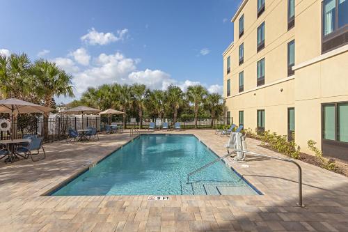 a swimming pool in front of a building at Pestana Orlando Suites - Lake Buena Vista in Orlando