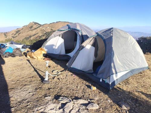 two tents sitting on top of a mountain at Himalayan Cloud Door Camps in Dehradun