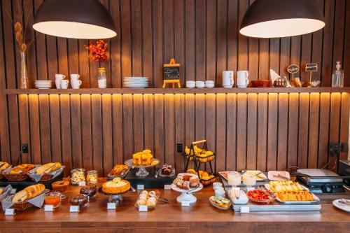a table with a buffet of food on it at Augusta Centro Hotel in Canela