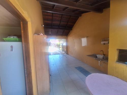 a hallway of a house with a sink and a counter at Casa mami 800 mts do mar in Capão da Canoa