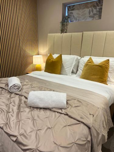 a large bed with two towels on top of it at Private Cosy 1Bd in town in Fareham