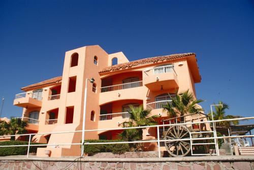 a building with a fence in front of it at Club Cantamar Beach Hotel & Marina in La Paz