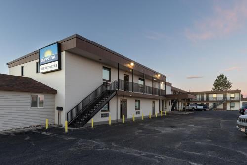 a building with a parking lot in front of it at Days Inn by Wyndham Wheatland in Wheatland
