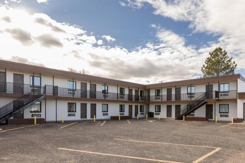 an apartment building with a parking lot at Days Inn by Wyndham Wheatland in Wheatland