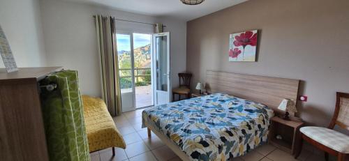 a bedroom with a bed and a sliding glass door at Ferme Ithurburia in Saint-Michel