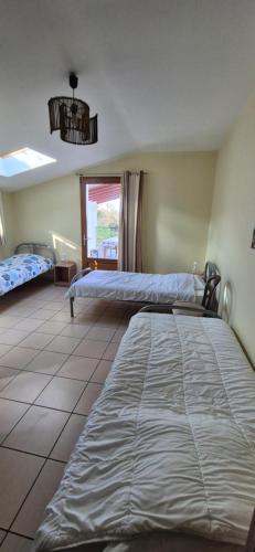 a bedroom with two beds and a window at Ferme Ithurburia in Saint-Michel