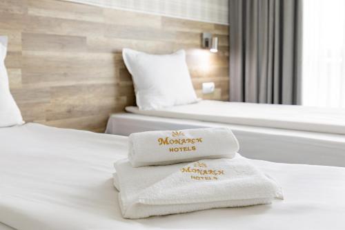 two towels on a bed in a hotel room at Hotel Iceberg Bansko in Bansko