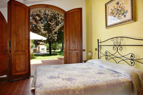 a bedroom with a bed and an open door at La Cerretola in Città della Pieve