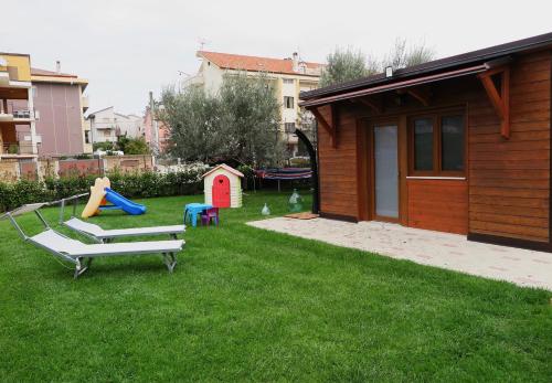 een achtertuin met een speeltuin en een speelhuis bij Dependance Con Giardino A Pescara in Pescara