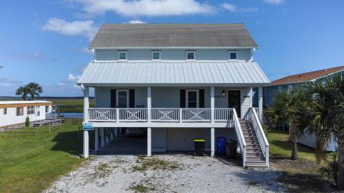 a white house with a porch and a staircase at Dig'n It in West Onslow Beach
