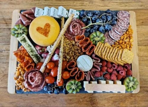 a tray filled with different types of food on a table at Domaine des Pins L'île au Dôme 