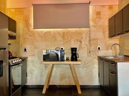 a kitchen with a table with a coffee maker on it at LA ESTANCIA, Casa EA Oaxaca, Centro Histórico, Balcón a las Montañas in Oaxaca City