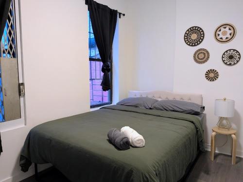 a bedroom with a bed with two towels on it at Private One Bedroom Apartment in Times Square & Central Park in New York