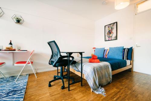 a bedroom with a bed and a desk and a chair at Central & Stylish with Pool & Gym Barbican Accomodation in London