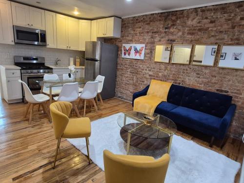 a living room with a blue couch and a table at Relax and unwind at this Chic Bed-Stuy Brownstone in Brooklyn
