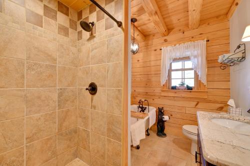 a bathroom with a shower and a toilet and a sink at 1 Mi to Lake Tillery Outdoor Retreat with Hot Tub! in Badin