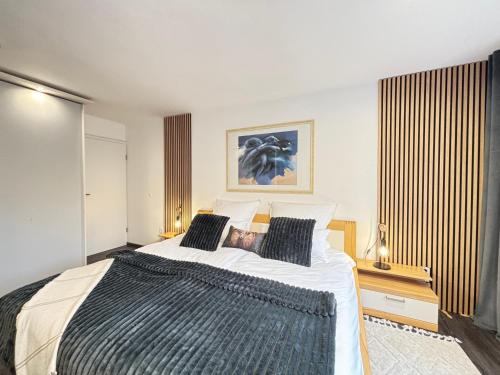 Serenity Stay Baiersbronn Kamin und Schwarzwaldblick في بايرسبرون: غرفة نوم بسرير كبير ونافذة كبيرة