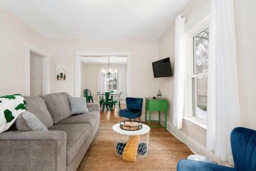 a living room with a couch and a table at Sweet Retreat 3 Mins to Notre Dame Eddy St Commons and Memorial Hospital in South Bend