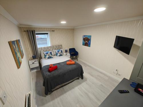 a bedroom with a bed with red pillows on it at The Jays Guest House in Aberdeen