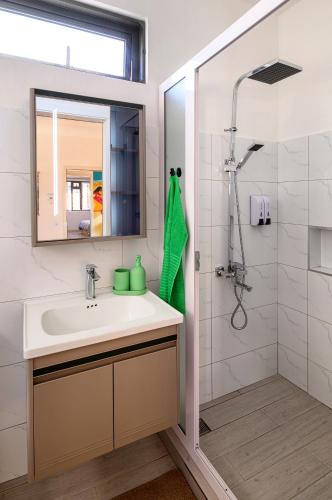a bathroom with a sink and a shower at Lamarel Beach House 2 in Flic-en-Flac